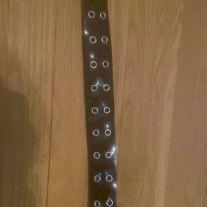 Black belt with silver holes.